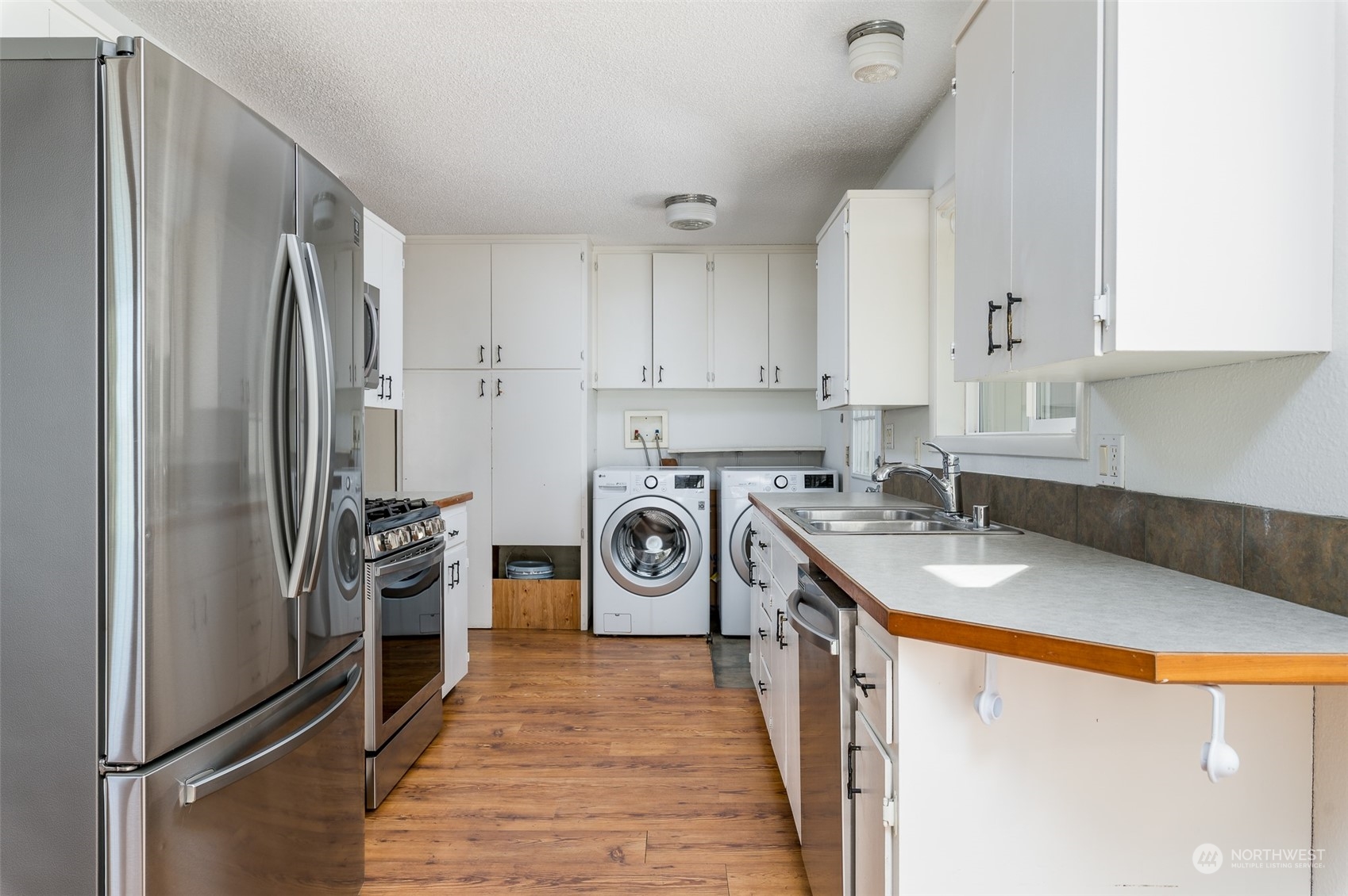 6912 Old Guide Road Lynden, WA 98264 - Photo 7 of 37 a kitchen with stainless steel appliances granite countertop a refrigerator and a stove