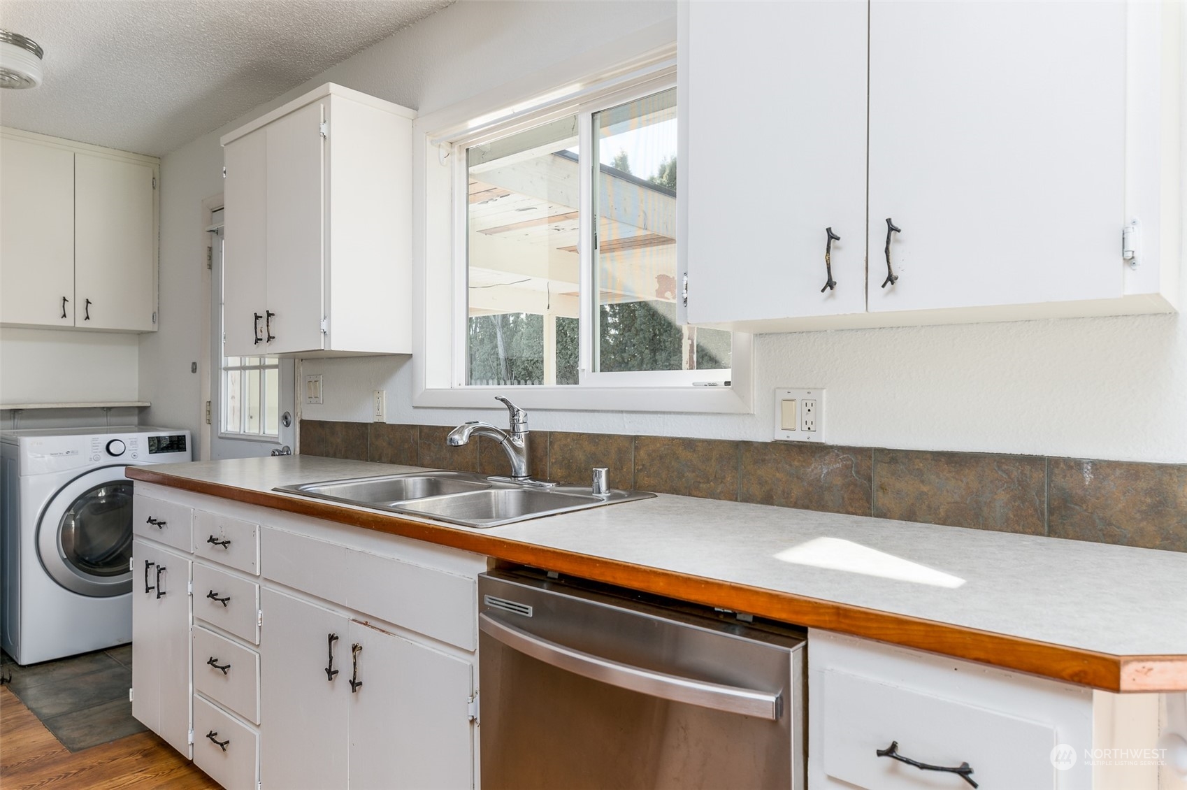 6912 Old Guide Road Lynden, WA 98264 - Photo 8 of 37 a kitchen with a sink cabinets and window