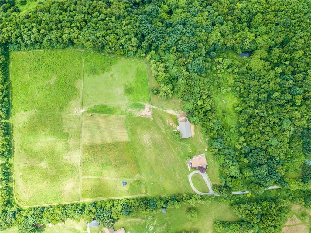 154 Chevy Lane Rochester, PA 15074 - Photo 19 of 25 Stunning Aerial view of property--all open fields belong to property in addition to the woods to the right of the photo (including the pond near the upper right corner of the photo). Smaller pasture exceeds 290' x 250' and larger pasture exceeds 622' x 265.' Water hydrant in each fenced pasture (fencing is all new and well maintained).