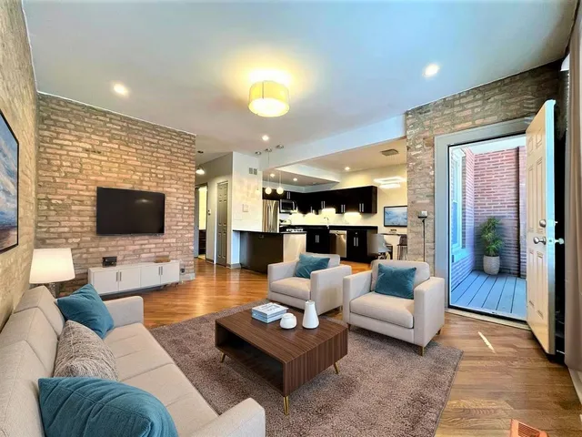 a living room with furniture a large window and a fireplace