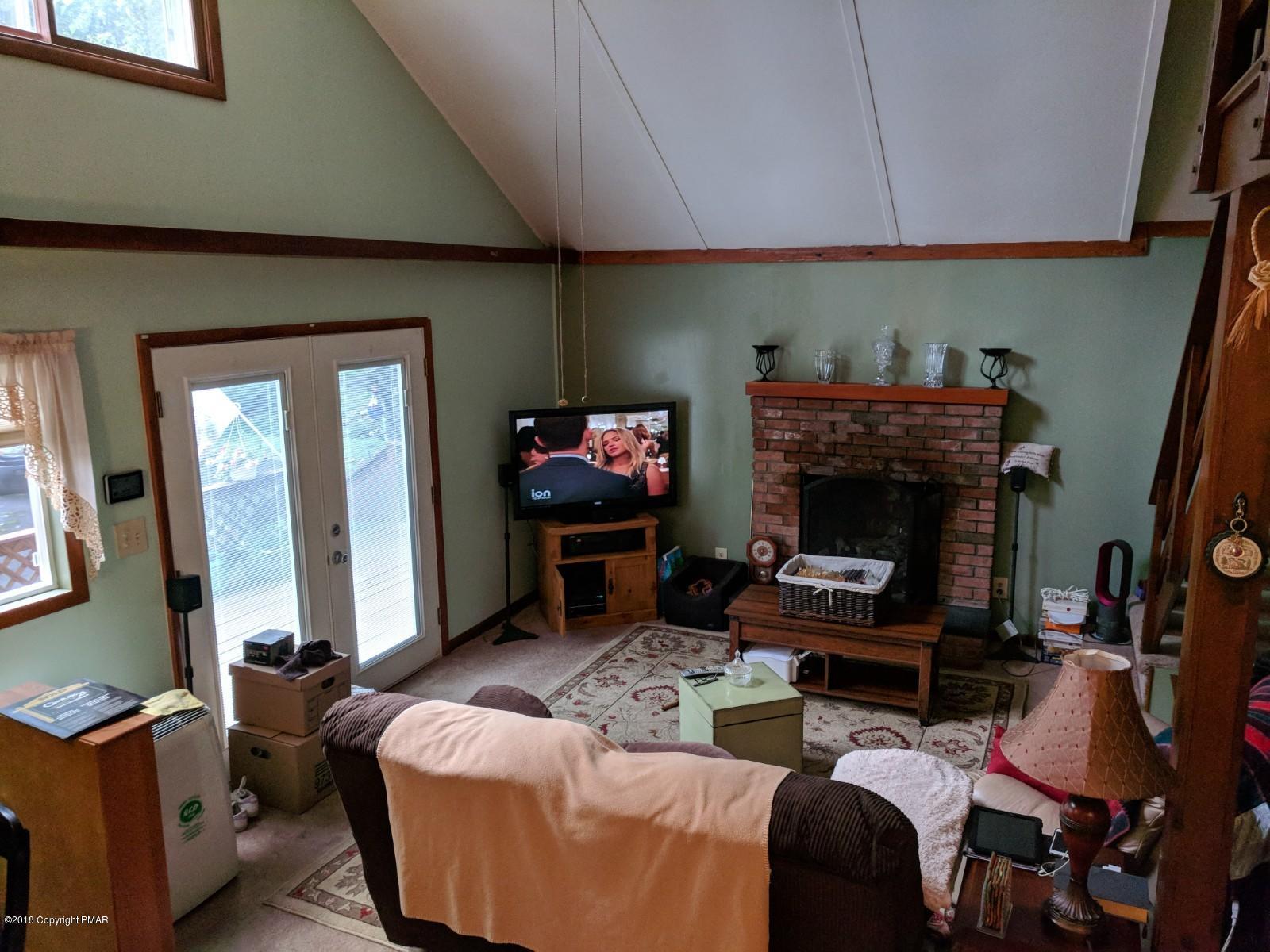 1109 Bracts Road Effort, PA 18330 - Photo 11 of 31 a living room with furniture a fireplace and a flat screen tv
