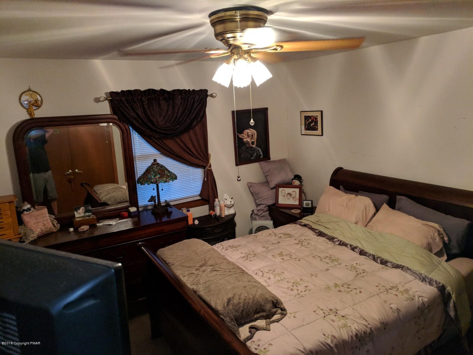 1109 Bracts Road Effort, PA 18330 - Photo 13 of 31 a bedroom with a bed and a chandelier