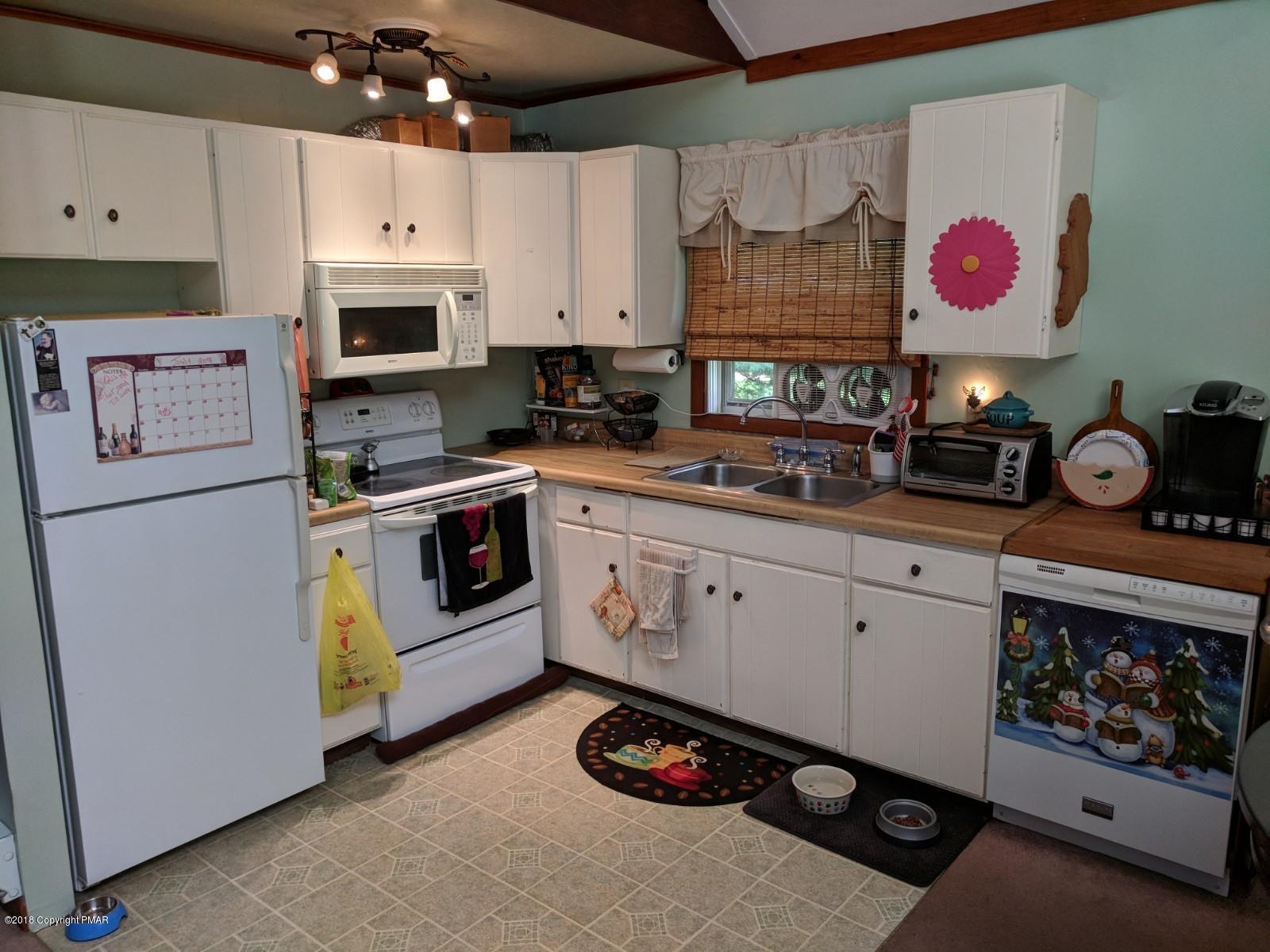 1109 Bracts Road Effort, PA 18330 - Photo 6 of 31 a kitchen with cabinets and white appliances