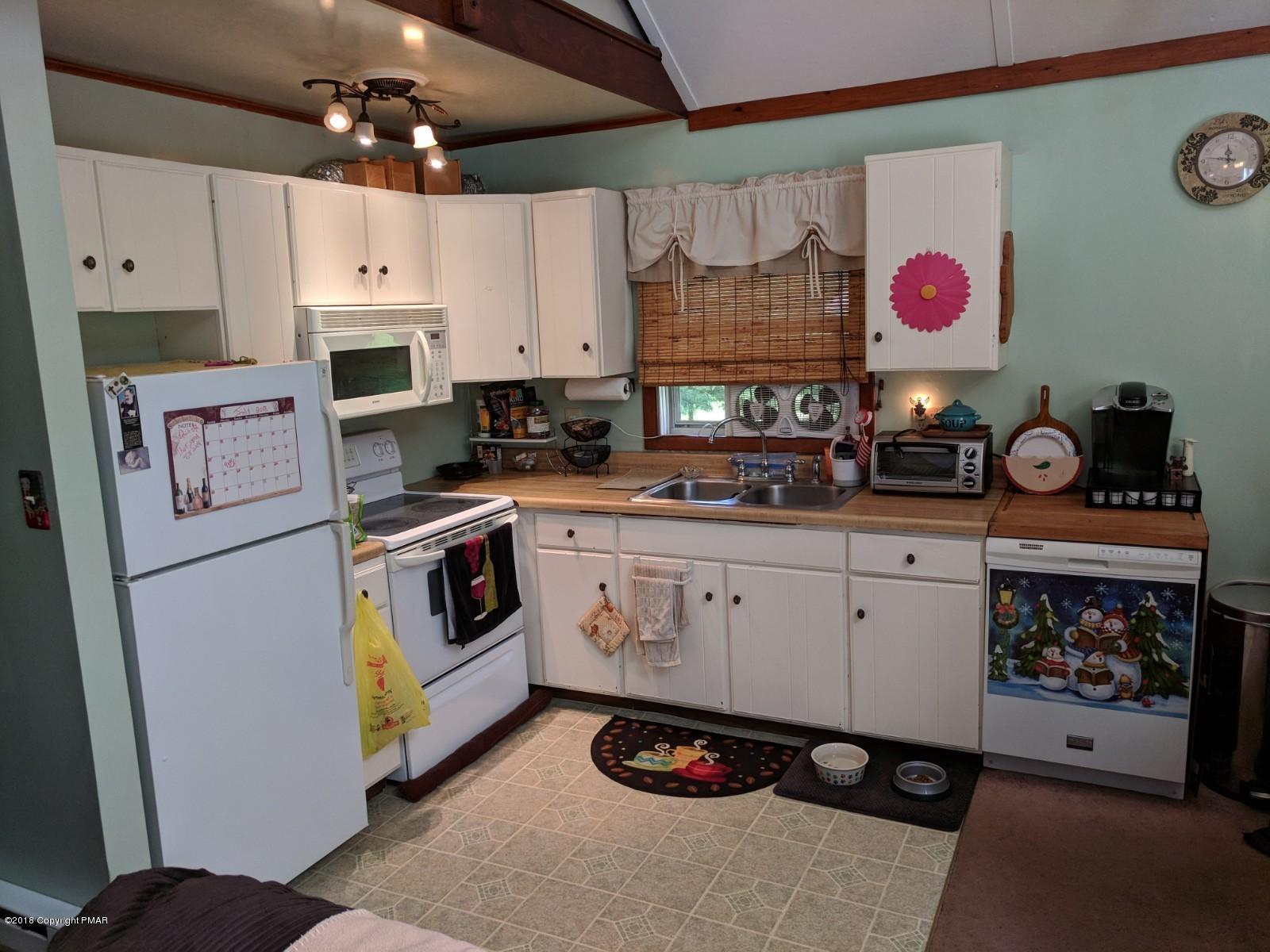 1109 Bracts Road Effort, PA 18330 - Photo 7 of 31 a kitchen with stainless steel appliances and white cabinets