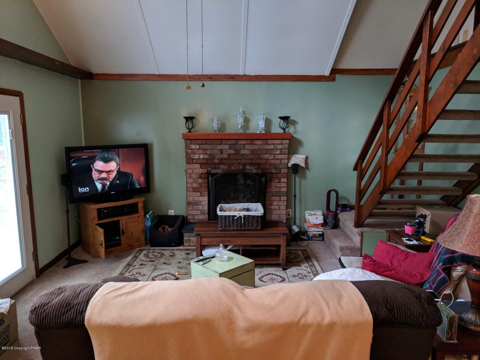 1109 Bracts Road Effort, PA 18330 - Photo 10 of 31 a living room with furniture a flat screen tv and a fireplace