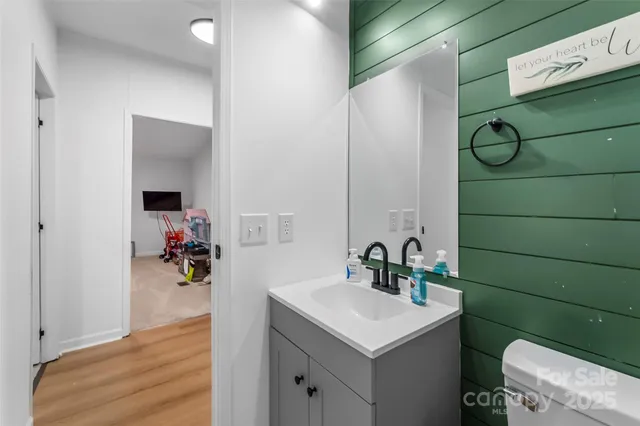 a bathroom with a sink toilet and mirror