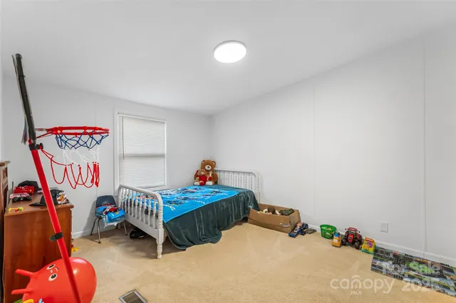 a bedroom with two beds and a couch