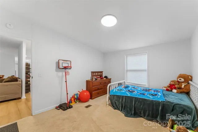 a bedroom with furniture and a wooden floor