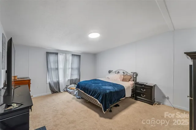 a bedroom with a bed and a dresser in it