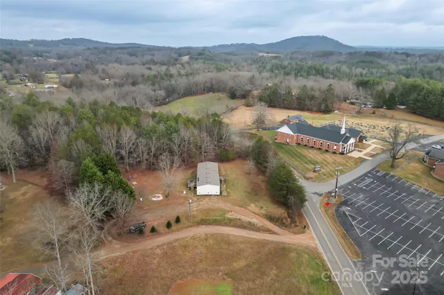 an aerial view of a house with mountain view