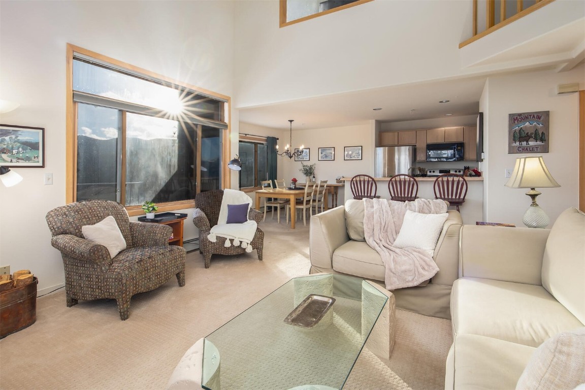 95600 Ryan Gulch Road, Unit 631 Silverthorne, CO 80498 - Photo 11 of 44 a living room with furniture and a glass door