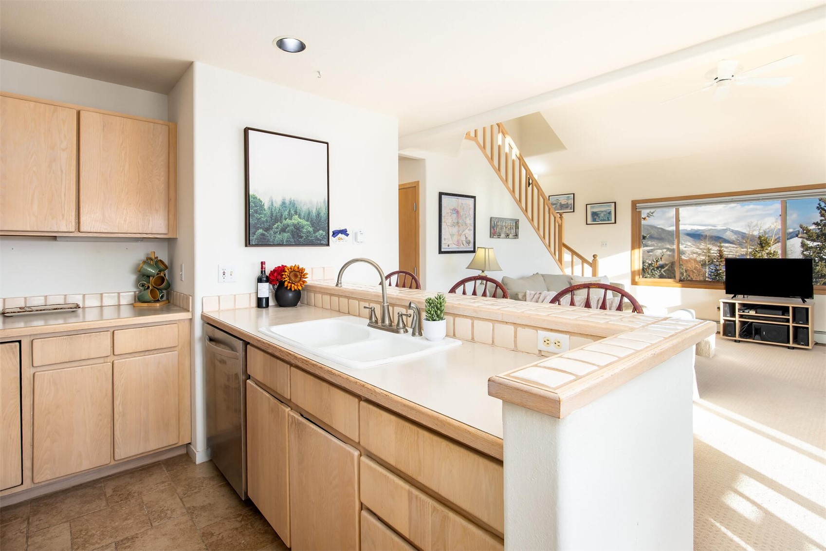 95600 Ryan Gulch Road, Unit 631 Silverthorne, CO 80498 - Photo 15 of 44 a kitchen with a sink and white cabinets