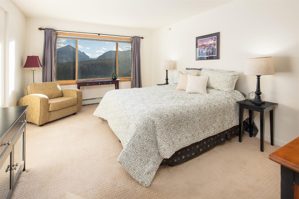 95600 Ryan Gulch Road, Unit 631 Silverthorne, CO 80498 - Photo 16 of 44 a bedroom with a bed and a large window