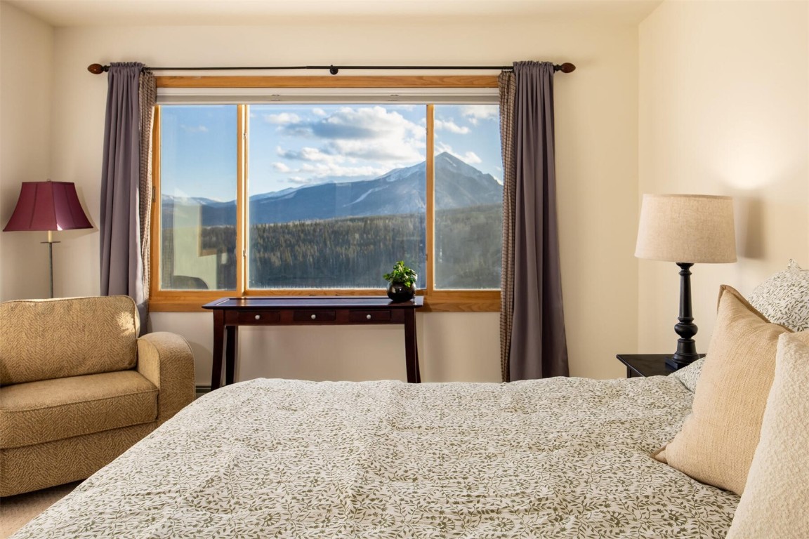 95600 Ryan Gulch Road, Unit 631 Silverthorne, CO 80498 - Photo 18 of 44 a bedroom with a large bed and a large window
