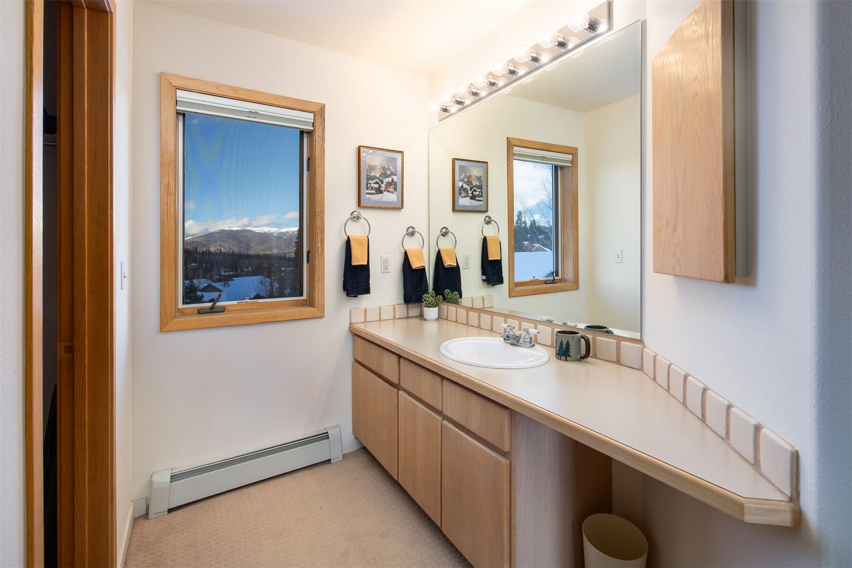 95600 Ryan Gulch Road, Unit 631 Silverthorne, CO 80498 - Photo 20 of 44 a en suite bathroom with a double vanity sink and a mirror