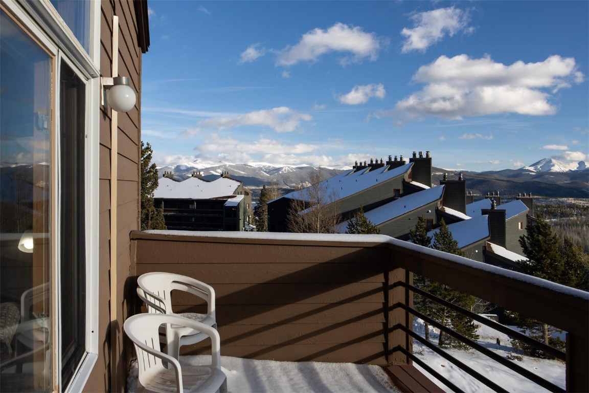 95600 Ryan Gulch Road, Unit 631 Silverthorne, CO 80498 - Photo 8 of 44 a view of a balcony with chairs and wooden fence