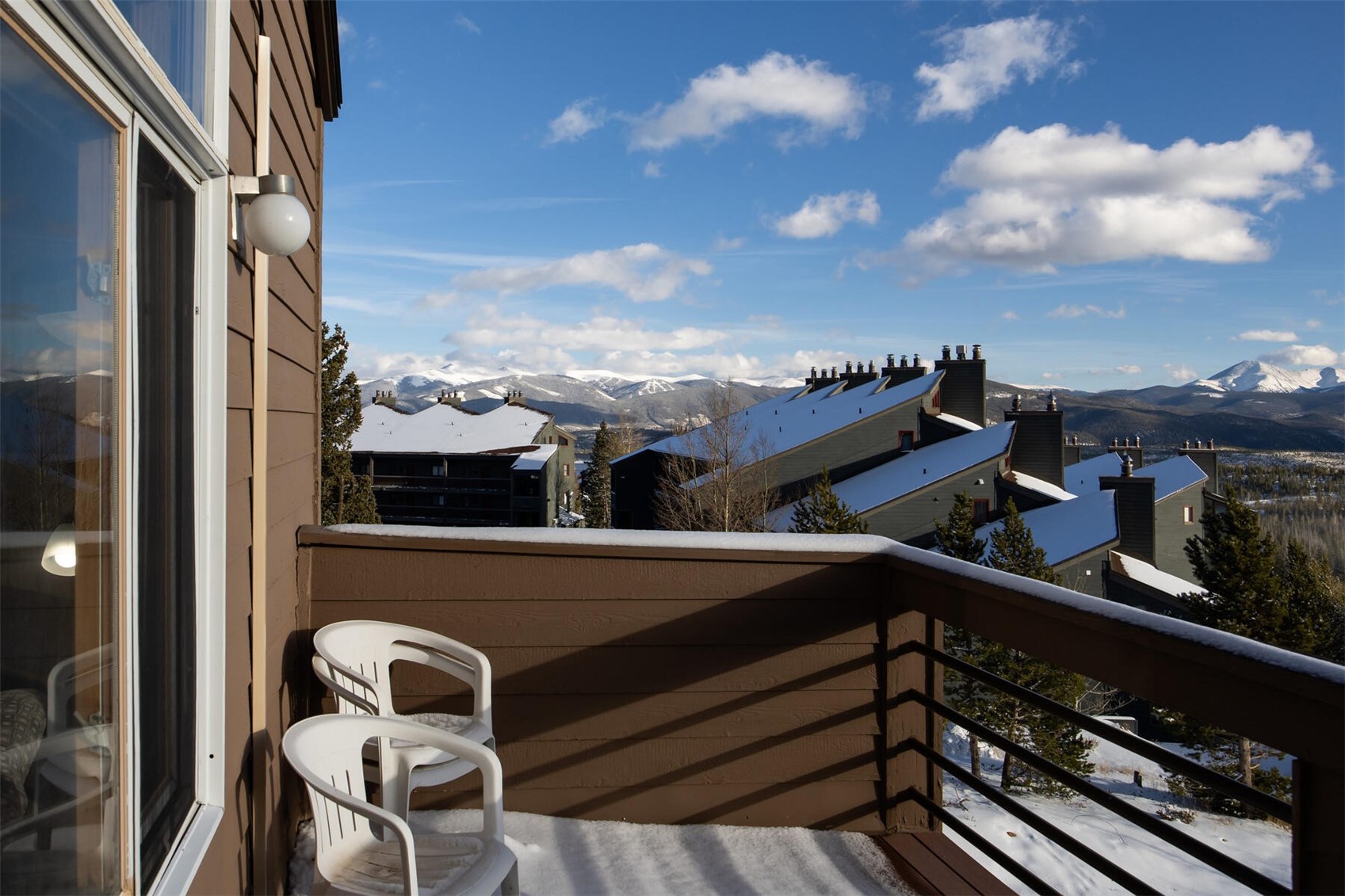 95600 Ryan Gulch Road, Unit 631 Silverthorne, CO 80498 - Photo 8 of 44 a view of a balcony with chairs and wooden fence