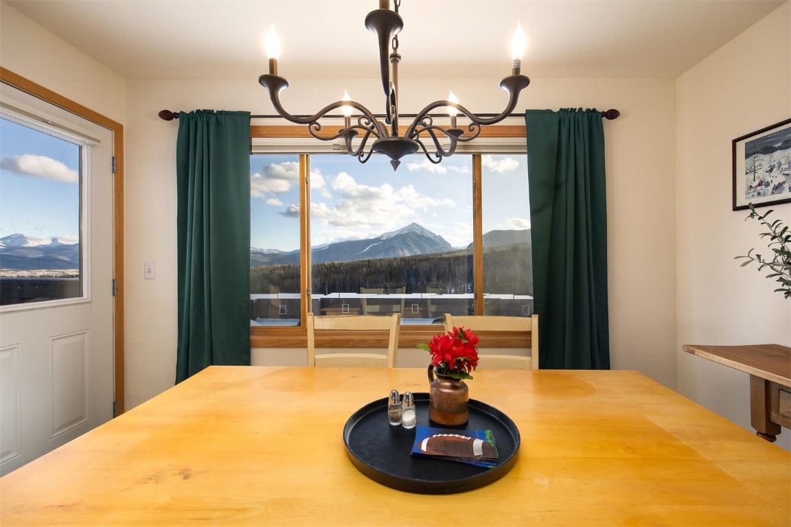 95600 Ryan Gulch Road, Unit 631 Silverthorne, CO 80498 - Photo 10 of 44 a view of a dining room with a chandelier