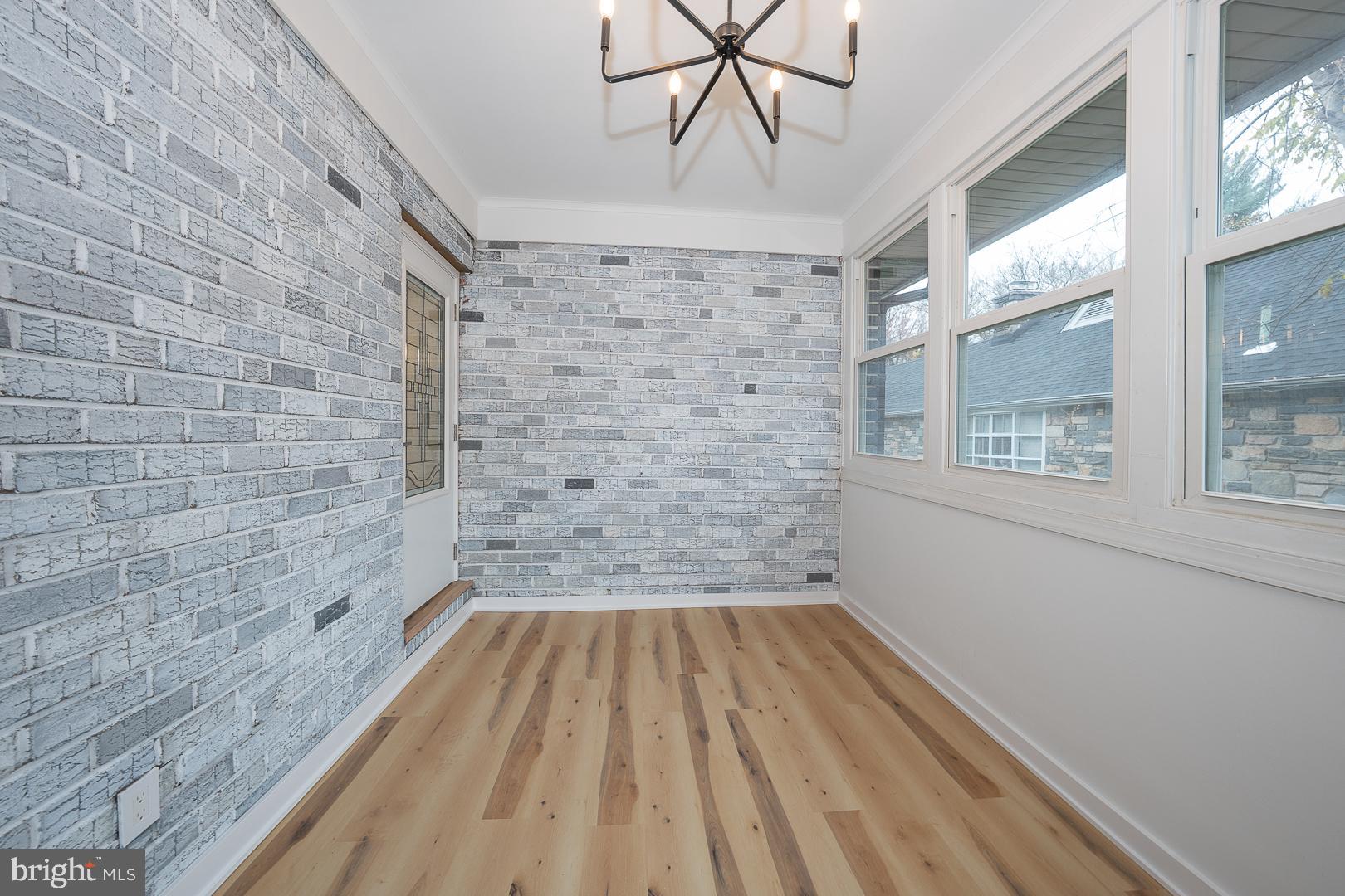 115 David Road Bala Cynwyd, PA 19004 - Photo 22 of 56 Sunroom next of Laundry room with stained brick