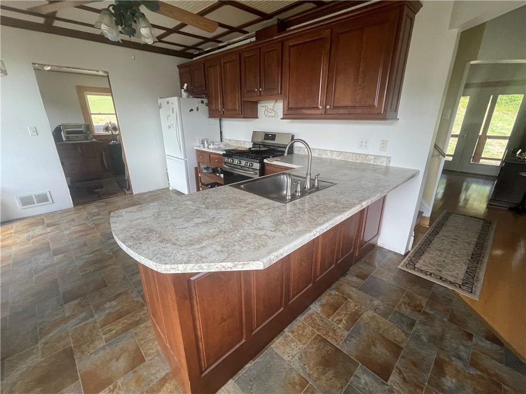 489 Jack Road Vandergrift, PA 15690 - Photo 21 of 46 a kitchen with stainless steel appliances granite countertop a sink a stove and a refrigerator