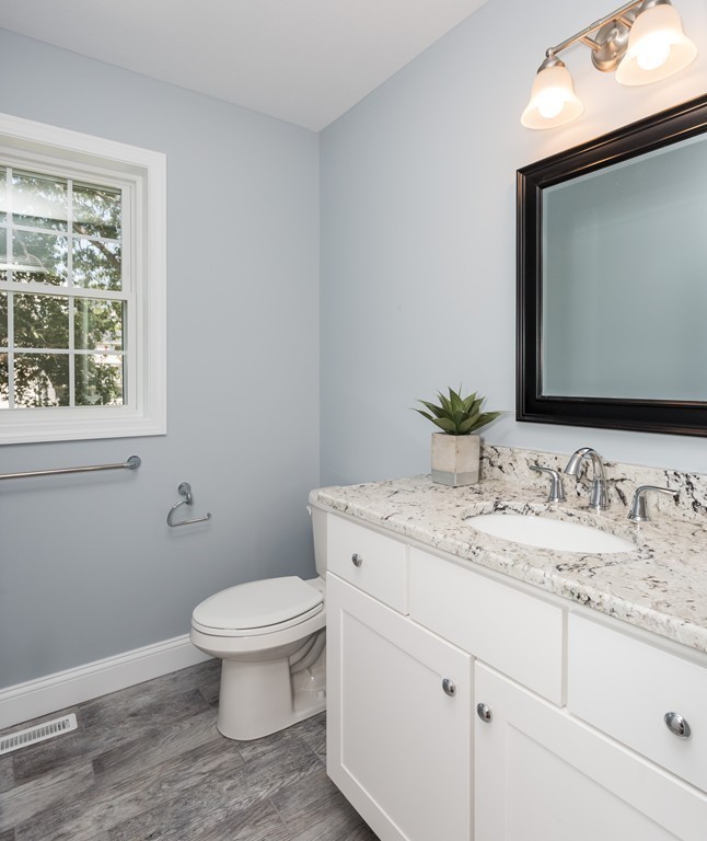 89 Wallace Street Springfield, MA 01119 - Photo 20 of 28 a bathroom with a granite countertop toilet sink and mirror