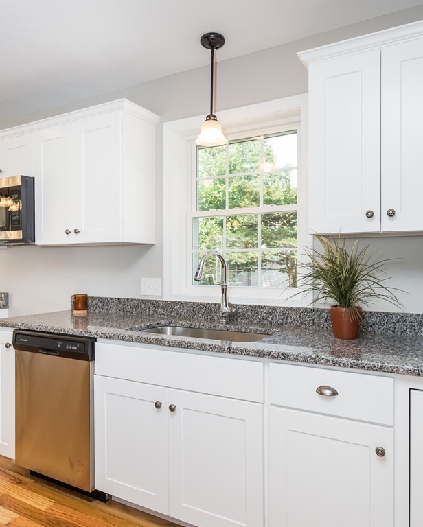 89 Wallace Street Springfield, MA 01119 - Photo 2 of 28 a kitchen with stainless steel appliances granite countertop white cabinets and a window
