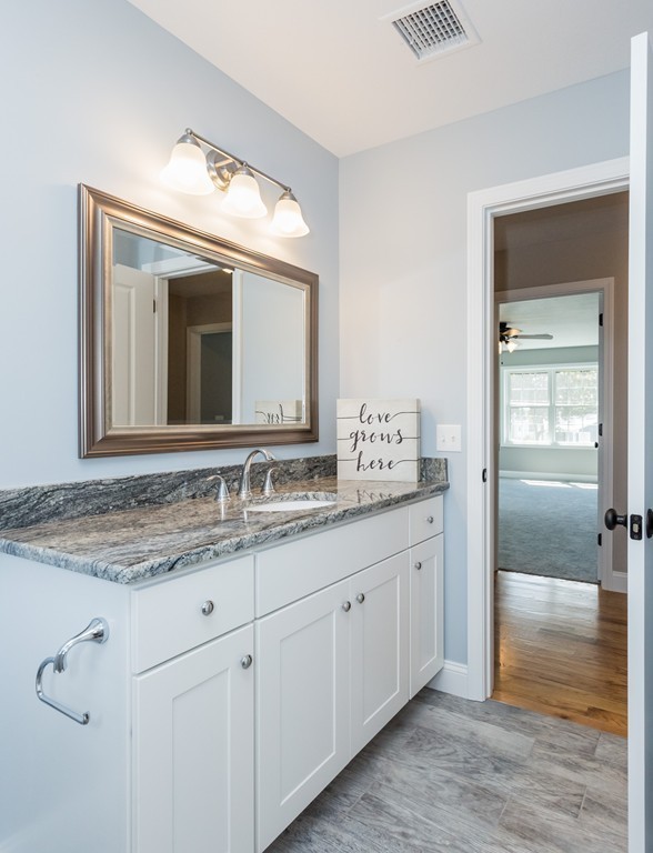 89 Wallace Street Springfield, MA 01119 - Photo 22 of 28 a bathroom with a granite countertop sink vanity and mirror