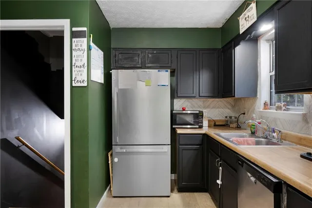 a white refrigerator freezer sitting in a kitchen