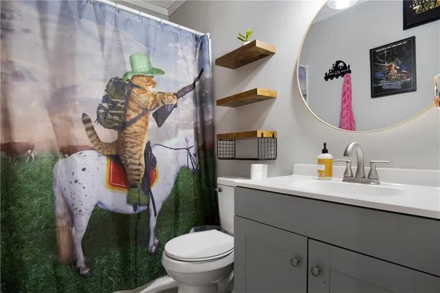 a bathroom with a toilet sink and mirror