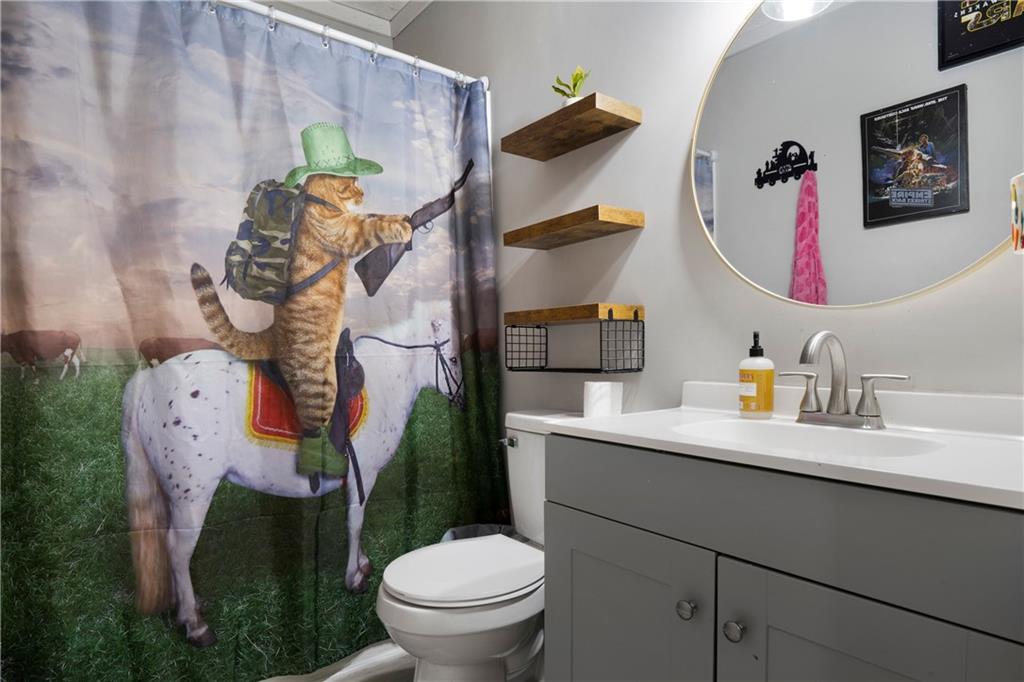 988 Davenport Road Southwest Dalton, GA 30721 - Photo 18 of 29 a bathroom with a toilet sink and mirror