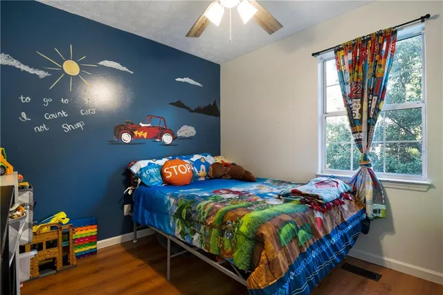 a bedroom with a bed and window