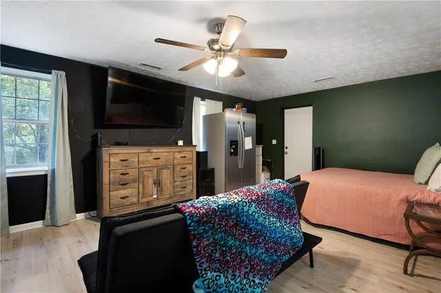 a bedroom with a bed and a television