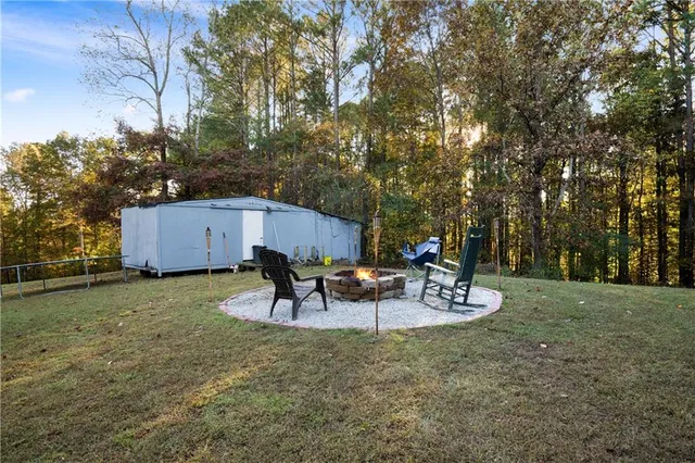 a view of a backyard with a patio and outdoor seating