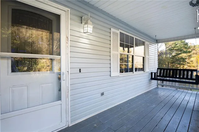 a view of front door deck and wooden floor