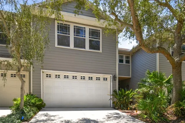 a front view of a building with plants