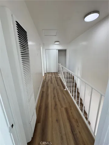 a view of a livingroom with wooden floor and stairs