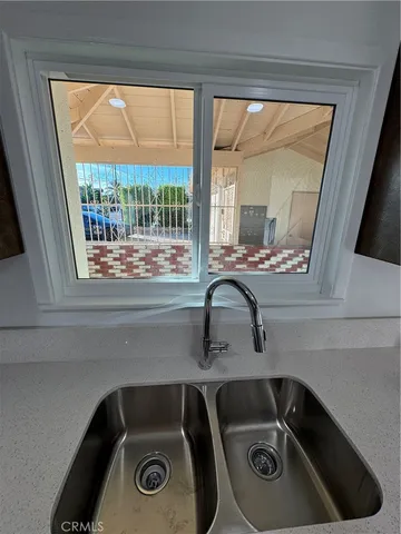 a kitchen with a sink and a refrigerator