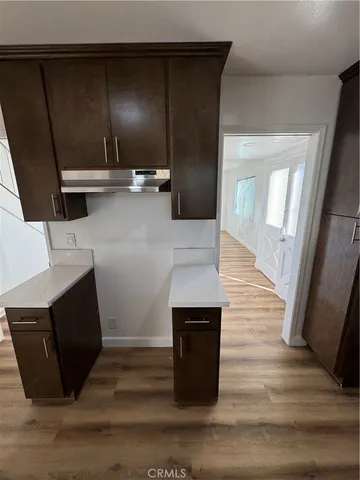 a view of kitchen with cabinets and wooden floor