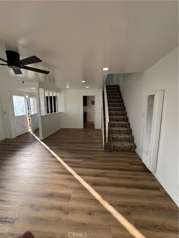 a view of entryway and hall with wooden floor