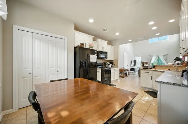 a large kitchen with lots of counter space and stainless steel appliances