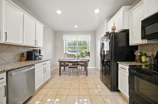 a kitchen with stainless steel appliances granite countertop a refrigerator stove microwave and sink