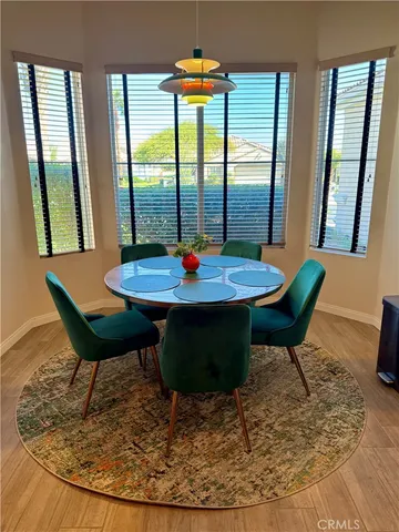a view of a dining room with furniture window and wooden floor