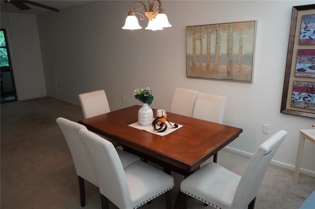 2415 Northeast 7th Street, Unit 8 Ocala, FL 34470 - Photo 13 of 25 a view of a dining room with furniture and wooden floor