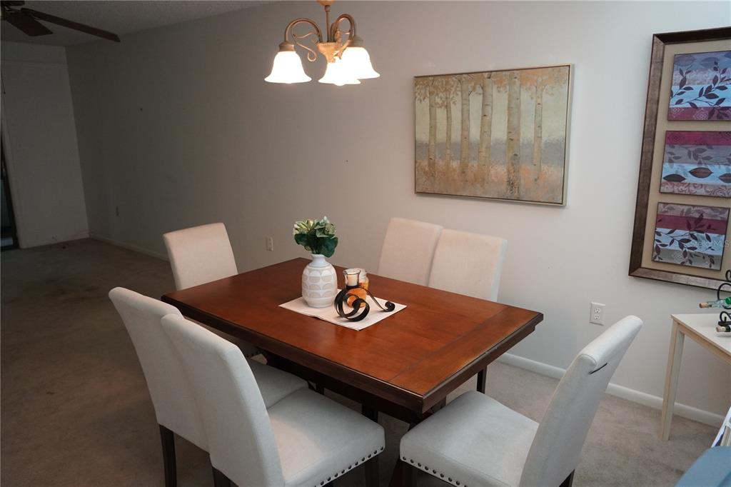 2415 Northeast 7th Street, Unit 8 Ocala, FL 34470 - Photo 14 of 25 a view of a dining room with furniture and wooden floor