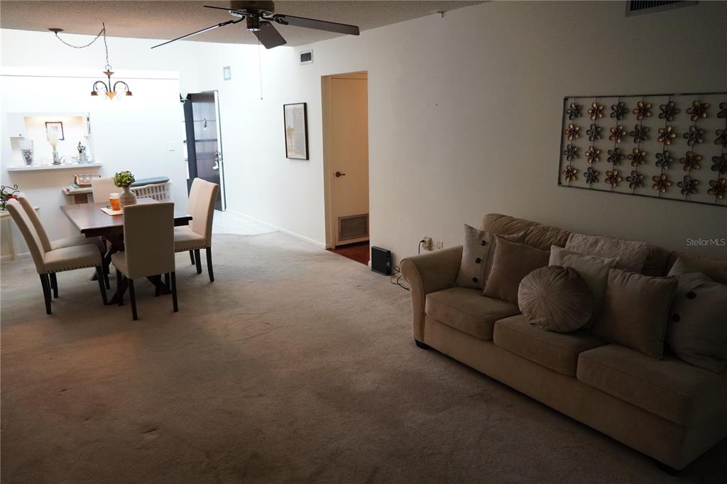 2415 Northeast 7th Street, Unit 8 Ocala, FL 34470 - Photo 16 of 25 a living room with furniture and a dining table