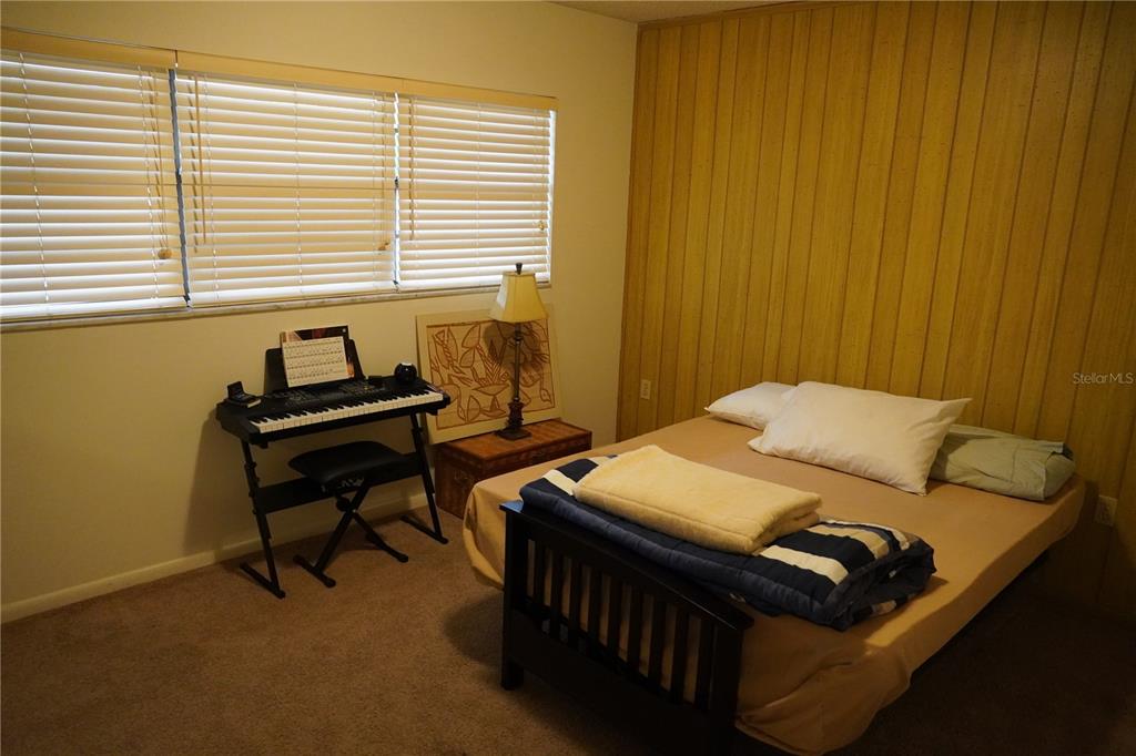 2415 Northeast 7th Street, Unit 8 Ocala, FL 34470 - Photo 18 of 25 a bedroom with a bed and a window