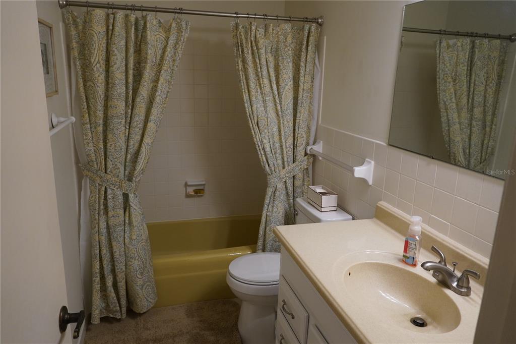 2415 Northeast 7th Street, Unit 8 Ocala, FL 34470 - Photo 21 of 25 a bathroom with a sink a toilet and shower