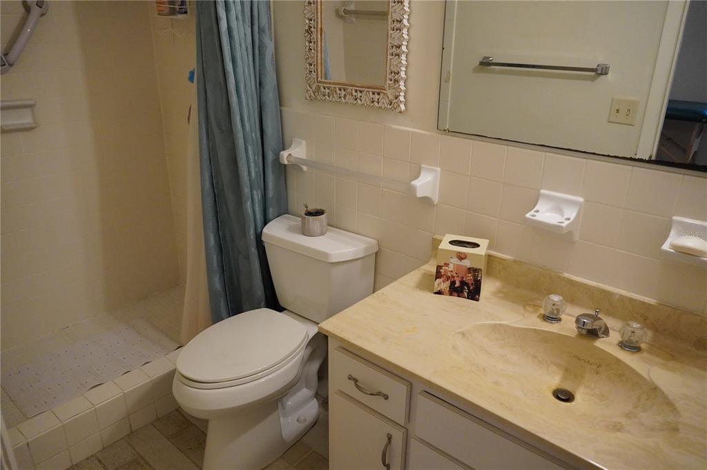 2415 Northeast 7th Street, Unit 8 Ocala, FL 34470 - Photo 25 of 25 a bathroom with a sink mirror vanity and toilet