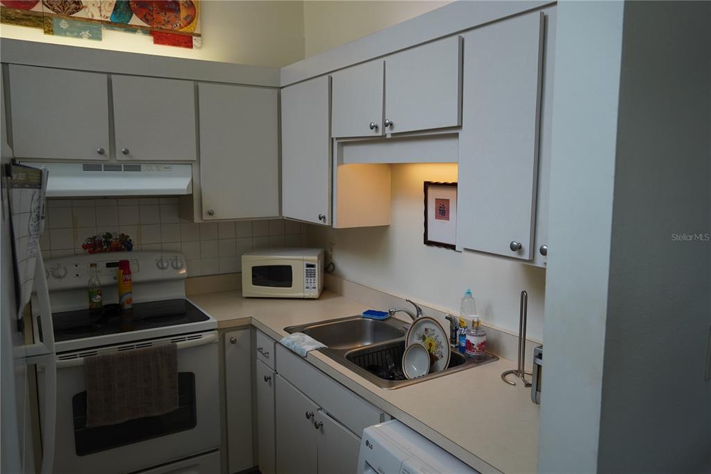 2415 Northeast 7th Street, Unit 8 Ocala, FL 34470 - Photo 10 of 25 a kitchen with stainless steel appliances granite countertop a sink stove and cabinets