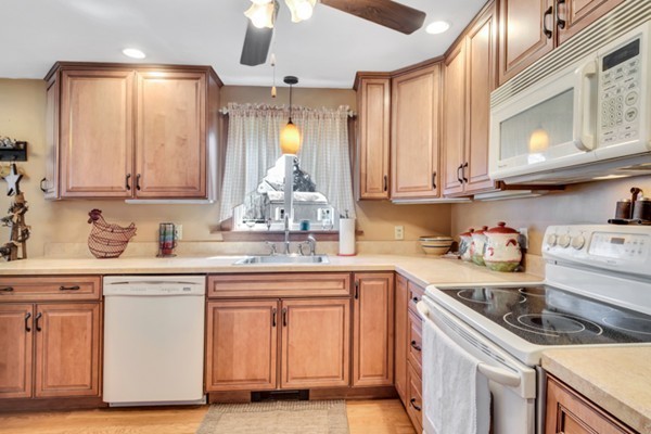 11 Melo Road Woburn, MA 01801 - Photo 3 of 22 a kitchen with granite countertop a sink and cabinets
